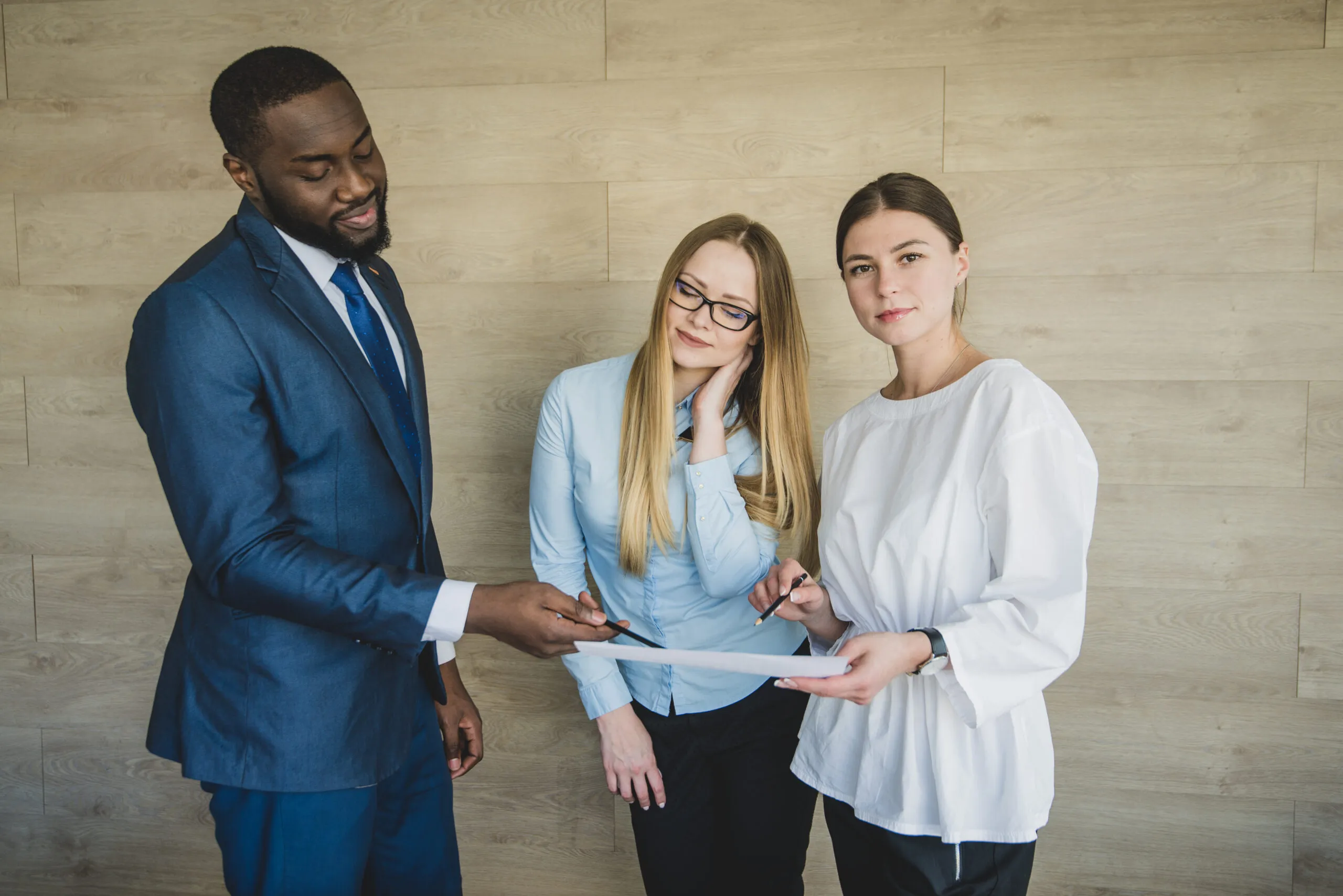 standing business people with paper having discussion