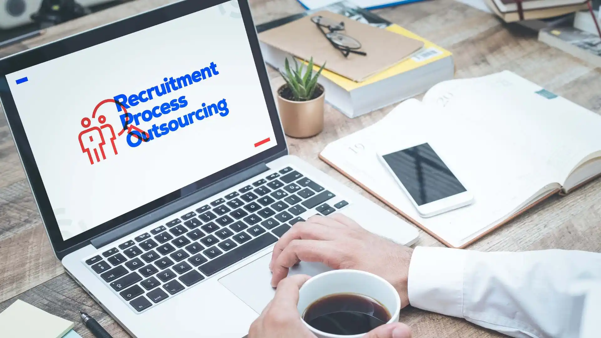 Laptop displaying "Recruitment Process Outsourcing" with a coffee cup.